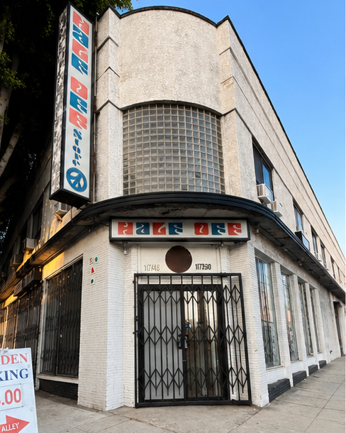 The streamline-moderne corner of 1748–1750 N Vermont — curved facade, glass-block tower, original masonry.